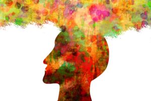 Side-profile drawing of a man's head, abstract with glowing colors instead of normal skin tone, mostly red, green, yellow and orange, with what resembles a large cloud of mist in the same colors coming out of the top of the head to form a little cloud