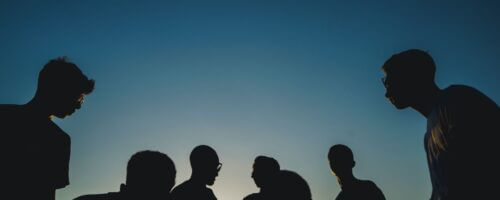 silhouette shot of several young people