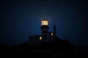 Illuminated lighthouse at night