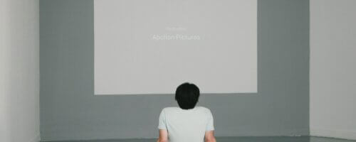 Person gazing at blank white canvas on wall