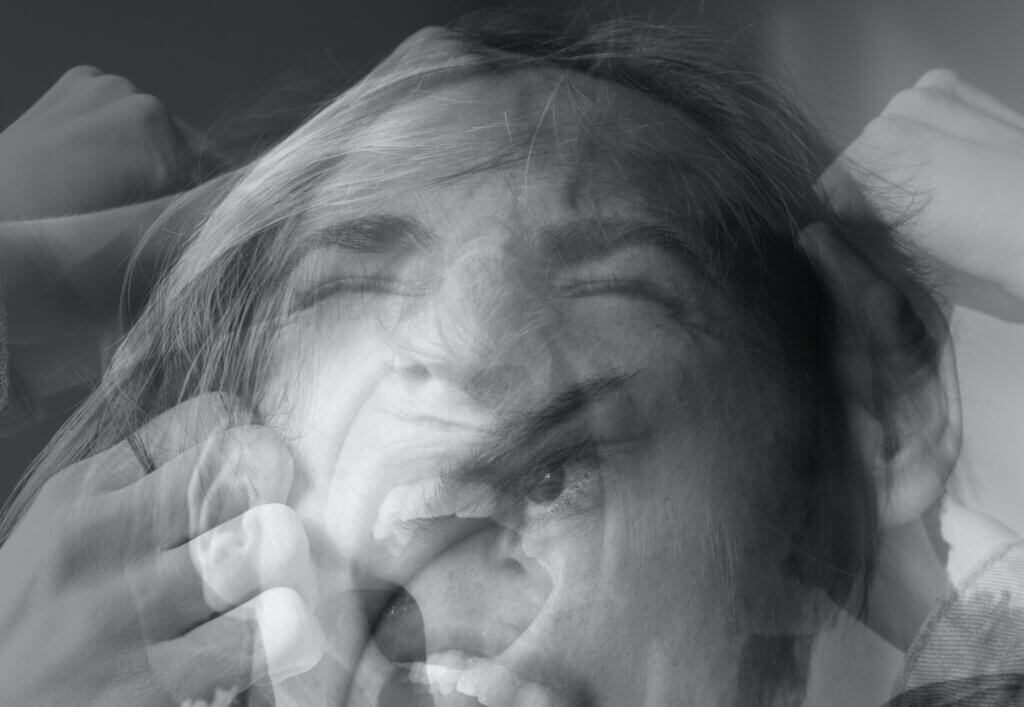 abstract b&w image of white person screaming in distress