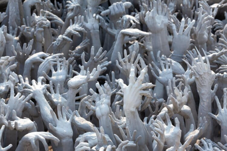 sea of eerie pale hands reaching up in distress