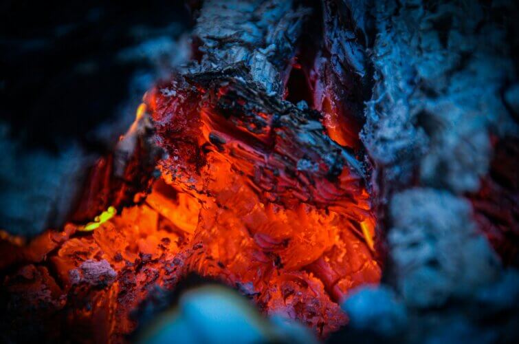 extreme closeup of the red-hot portion of a log burning down soon to its final embers