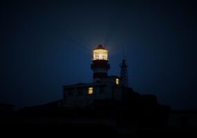Illuminated lighthouse at night
